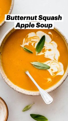 two bowls filled with soup on top of a white table