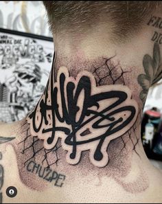 a man's neck with black and white graffiti on the back of his neck