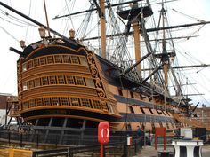 a large wooden ship sitting in the water