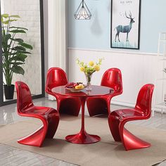 a red table and four chairs in a room