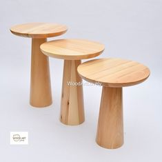 three wooden stools sitting next to each other