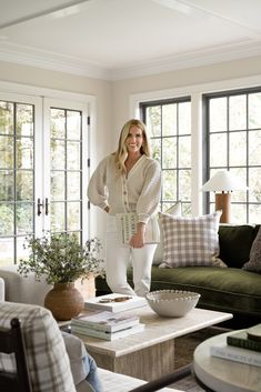 a woman standing in the middle of a living room