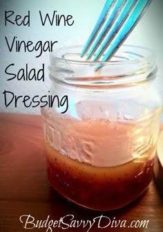 red wine vinegar, vinegar salad dressing in a mason jar with tongs sticking out