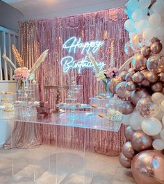 a birthday party setup with balloons, cake and confetti on the side table