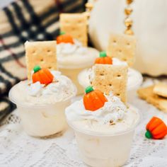 small cups filled with whipped cream and decorated pumpkins