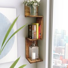 two wooden shelves with books and vases on them