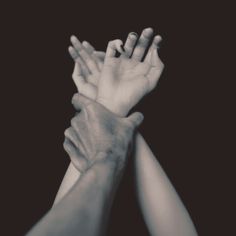 black and white photograph of two hands reaching for each other