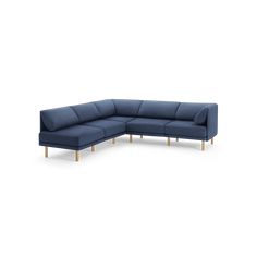 a blue sectional couch with wooden legs on an isolated white background, viewed from the front