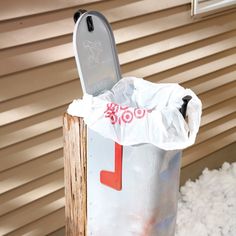 a mailbox covered in snow with the letter j on it's front door