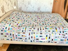 a bed with a quilt on top of it