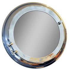 a round mirror is shown on a white background