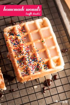 two waffles with chocolate and sprinkles on a cooling rack