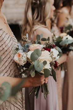 the bridesmaids are holding their bouquets together