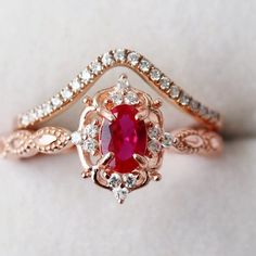 Gorgeous Vintage Inspired Ruby Ring ►Available in 14K solid rose gold. This ring can be also custom made in white or yellow gold. Metal can be upgraded to 18K at additional cost. ►Purchase includes ruby ring only. Matching chevron wedding band is sold separately. Please contact us to request a custom quote. ►Average band width: 1.7 mm ►Gemstone information Center Stone: Ruby Gem size: 6.0 x 4.0 mm Average carat Weight: 0.5 ct. Gemstone creation: Natural Grade: AAA Hardness: 9 (Mohs scale) ►Accen Milgrain Wedding Ring, Rose Gold Promise Ring, Milgrain Ring, Popular Engagement Rings, Gold Promise Rings, Engagement Ring For Women, Ruby Engagement Ring, Creating Jewelry, Wedding Ring Designs