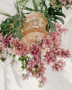 pink flowers and green leaves on a white background with a burlocked teddy bear