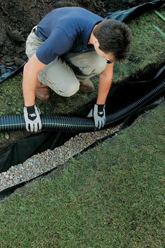 a man is working on a drainage system