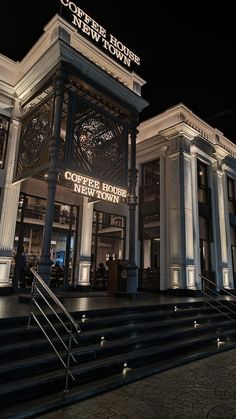 the entrance to coffee house new town lit up at night