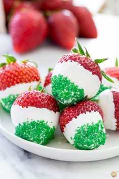 strawberries with white and green frosting on a plate