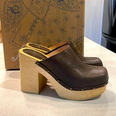 Slip-On Style, Leather Uppers, Wooden Platform Sole, Chunky Block Heel, Square Toe, Lined Footbed, Stud Details Leather, Wood **All Items Come From Smoke And Pet Free Environment** Wooden Clogs, Platform Clogs, Clog Heels, Free People Shoes, Chunky Block Heels, Mule Clogs, Mules Shoes, Me Too Shoes, Block Heels