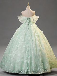 Celebrate elegance in this Mint Green Evening Dress, designed to exude sophistication and grace at every turn. Crafted from layers of soft, mint green tulle, this gown is adorned with exquisite floral appliqués that cascade down its length, adding depth and enchantment to the fabric's gentle flow. The bodice features a structured corset that cinches at the waist, creating a flattering silhouette that celebrates the fullness of plus-size figures. This corset is not only a nod to classic style but also ensures a perfect, tailored fit, enhancing comfort and confidence. The dress's romantic off-shoulder design, complemented by airy butterfly sleeves, frames the neckline beautifully, adding a touch of delicate charm. Flowing effortlessly to a floor-length finish, the skirt swirls with every ste Green Enchanted Dress, Green Princess Style Dress For Debutante Ball, Princess Style Green Ball Gown With Fitted Bodice, Green Formal Ball Gown With Fitted Bodice, Green Ball Gown With Fitted Bodice For Formal Occasions, Formal Green Ball Gown With Fitted Bodice, Princess Style Green Dress For Quinceanera, Fitted Green Organza Ball Gown, Green Organza Evening Dress For Prom