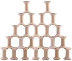 a set of wooden pegs stacked up in the shape of a pyramid on a white background