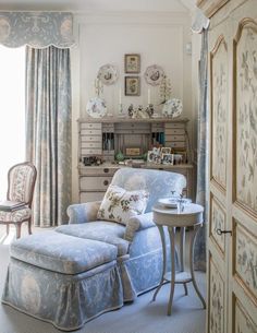 a living room filled with furniture next to a window covered in curtains and drapes