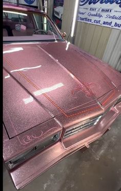 a pink car is parked in a garage