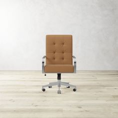 an office chair sitting on top of a hard wood floor next to a white wall