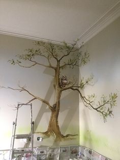 a tree painted on the wall in a room