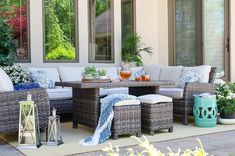 an outdoor patio with wicker furniture and potted plants