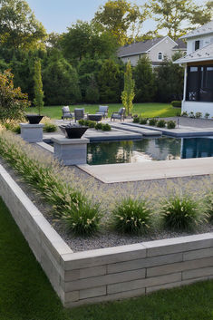 an outdoor pool surrounded by grass and plants