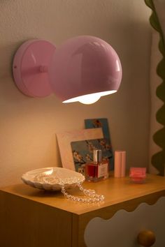 a table with a lamp on top of it next to a plate and other items