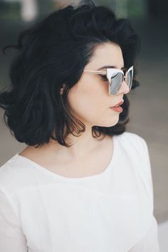 a woman with dark hair wearing sunglasses