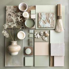 an assortment of different items are displayed on a table with grey walls and white vases