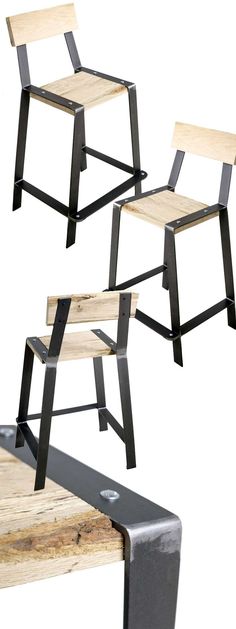 three wooden chairs sitting on top of each other with metal legs and backrests