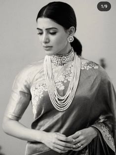 a woman in a sari with pearls on her neck