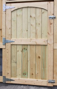 a close up of a wooden gate with metal handles