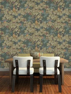 two white chairs sitting at a wooden table in front of a wallpapered background