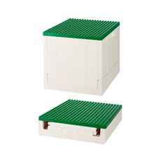 two white and green lego boxes sitting side by side