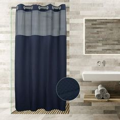 a blue shower curtain in a bathroom next to a sink