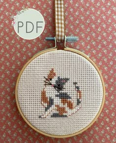 a cross stitch pattern with a cat on it's back and the words pddf above it