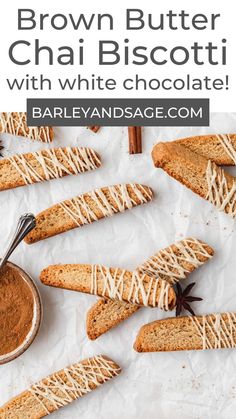 brown butter chai biscotti with white chocolate on parchment paper and cinnamon sticks