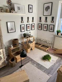 a living room filled with lots of furniture and pictures on the wall above it's radiator