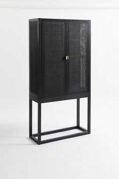 a black cabinet sitting on top of a white floor