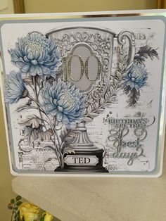 a close up of a card with flowers and a trophy on it's side