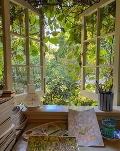 there are many books on the table by the window