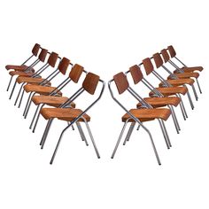 a bunch of chairs sitting next to each other on top of a white surface with no one in them