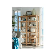 a living room filled with lots of furniture and bookshelves next to a window