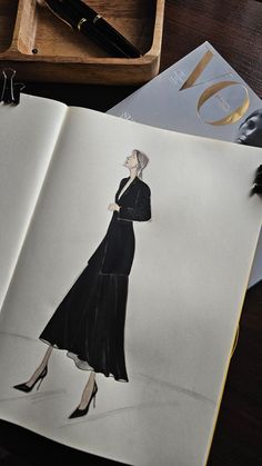 an open book with a drawing of a woman in a black dress