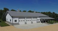 an aerial view of a large white building with two garages